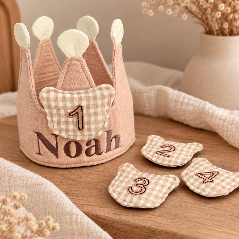 Beige meegroeiende verjaardagskroon met naam Noah in donkerbruine geborduurde letters en verwisselbare cijfers 1 t/m 4. Perfect voor de eerste verjaardagen.